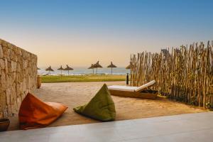 an outdoor area with umbrellas and a beach withermottermott at Tulum Beach Resort Dakhla in Dakhla