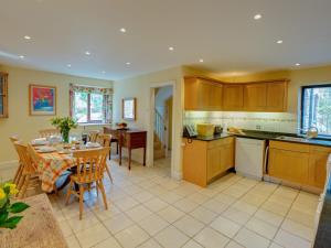 a kitchen and dining room with a table and chairs at Brook Cottage in Newton Ferrers