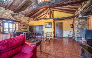 a living room with a red couch and a table at 1 Bedroom Stunning Apartment In Fonsagrada in Fonsagrada