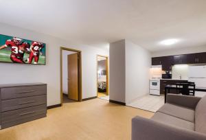 a living room with a couch and a kitchen at Red Roof Inn Lawrenceburg in Lawrenceburg