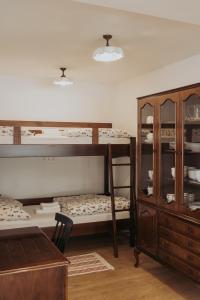 a room with two bunk beds and a dresser at Apartments Možinetova hiša in Šentjošt nad Horjulom