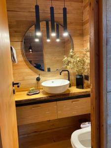 a bathroom with a sink and a mirror at La Casita- imawi in Belén de Escobar
