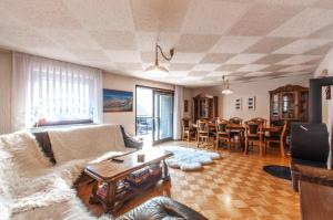 a living room with a couch and a table at Holiday Chalet near Bled 