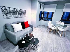 ein Wohnzimmer mit einer Couch und einem Tisch in der Unterkunft AP TURIST VELÁZQUEZ in Alicante