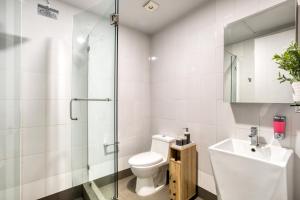 a bathroom with a toilet and a sink and a shower at Eazy Rio by ULIV in Tijuana