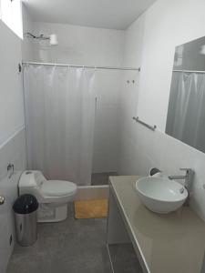 a bathroom with a sink and a toilet and a shower at Hermosa y espléndida casa en Oxapampa in Oxapampa +11 photos
