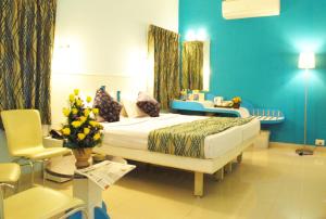 a hospital room with a bed and a table at Hotel Pandian in Chennai