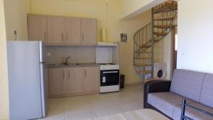 a kitchen with a refrigerator and a spiral staircase at DESPOINA-Triopetra in Triopetra