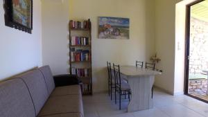 a living room with a couch and a table with chairs at DESPOINA-Triopetra in Triopetra +33 photos