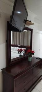 a bedroom with a large mirror on a dresser at Cheers in Evander