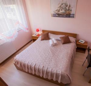 a bedroom with a large bed with a boat on it at Hotel Riviera Sanremo in Sanremo