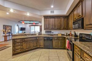 a large kitchen with wooden cabinets and appliances at Bella Sirena Luxury Resort 205-D in Puerto Peñasco