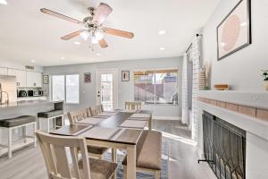a dining room with a table and chairs and a fireplace at Chandler Home with Yard and Grill 3 Mi to Downtown! in Chandler