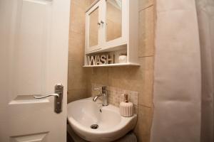 a small bathroom with a sink and a mirror at Cottage - Sleeps4 - PetFriendly - Garden - ByBeach in Saint Annes on the Sea +22 photos