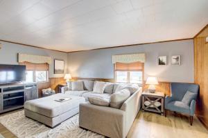 a living room with a couch and a tv at Cozy Wisconsin Abode Walk to Lake Michigan! in Algoma