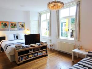 ein Schlafzimmer mit einem Bett und einem TV auf einem Tisch in der Unterkunft B&B Vierwinden in Vlissingen