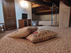 two pillows on a bed in a bedroom at Clockwise in Viterbo