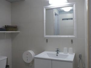 a white bathroom with a sink and a mirror at Auberge de Trente Pas in Saint-Ferréol-Trente-Pas +23 photos