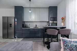 een keuken met zwart-witte kasten en een aanrecht bij Apartment Aida in Sarajevo