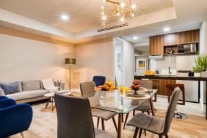a dining room and living room with a table and chairs at Eazy Rio by ULIV in Tijuana