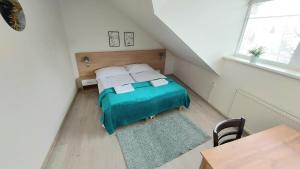 a small bedroom with a bed in a attic at Apartmán pre 5 osôb, 2 spálne, Banská Bystrica Podlavice 24h self checkin in Banská Bystrica