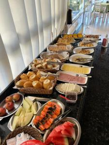 a buffet line with many different types of food at Pousada Rosália in Penha
