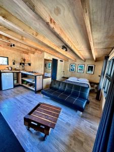 a living room with a couch and a table at Molco Cabins Palafito in Pucón