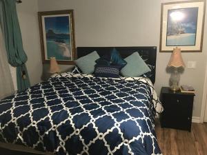 a bedroom with a blue and white bed with two lamps at Romantic Coastal Private Room in Oxnard