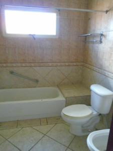 a bathroom with a toilet and a tub and a sink at 3104 Costa Bonita Beach Condo Culebra in Culebra