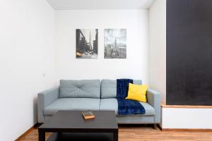 a living room with a blue couch and a table at 054 квартира ЖК Софія Резиденс, 1 поверх in Kyiv +18 photos