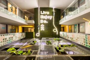 arium of a building with a lobby with plants at Eazy Rio by ULIV in Tijuana
