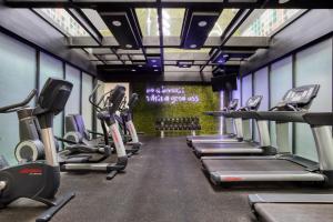 a gym with a row of treadms and cardio machines at Eazy Rio by ULIV in Tijuana