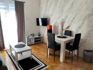 a living room with a white table and chairs at Vuk in Zlatibor