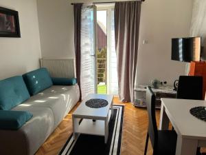 a living room with a couch and a table at Vuk in Zlatibor +5 photos