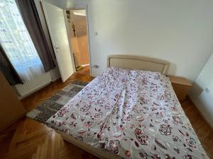 a bed in a room with a bedspread on it at Vuk in Zlatibor