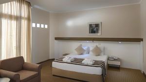Postel nebo postele na pokoji v ubytování Green Max Hotel
