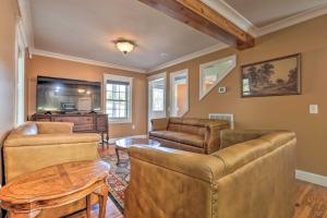 a living room with leather furniture and a tv at Secluded Getaway Home with Trails and Waterfall! 