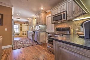 a large kitchen with wooden floors and stainless steel appliances at Secluded Getaway Home with Trails and Waterfall! 