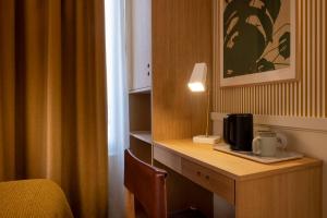 a room with a desk with a coffee maker on it at Le Petit Oberkampf Hotel & Spa in Paris
