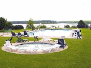 a large swimming pool with chairs and a table at THE ONE Chalet in Albrightsville