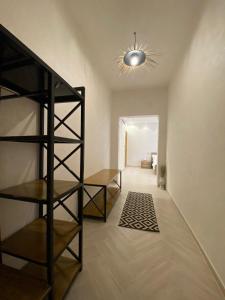 a hallway with shelves and a ceiling with a light at فيلا آفيري Aviary villa in Al-ʿUla