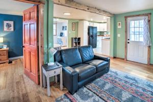a living room with a leather couch and a table at Indiana Vacation Rental Near Lake Michigan in Valparaiso