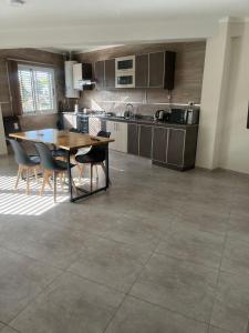 a kitchen with a table and chairs in a room at Departamento Ciudad de Tupungato in Tupungato