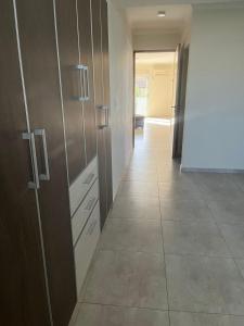 a hallway with wooden cabinets and a tile floor at Departamento Ciudad de Tupungato in Tupungato