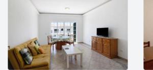 a living room with a couch and a table at Apartment Moni Cabanas de Tavira Algarve in Cabanas de Tavira