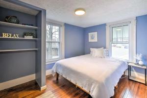 a blue bedroom with a bed and a window at New! The Docks @ Waterside - Lake Front Hot Tub! in Akron