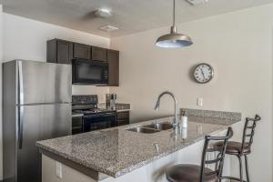 a kitchen with a sink and a refrigerator at Kasa University Avenue Minneapolis in Minneapolis