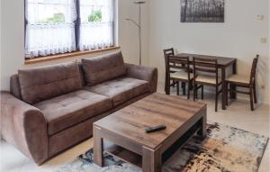a living room with a couch and a table at Amazing Apartment In Berlin-bohnsdorf With 1 Bedrooms And Wifi in Berlin