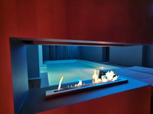 a room with a fireplace with a swimming pool at Alysa - Suite Wellness & Spa in Giarre