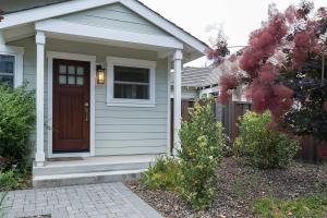 a house with a brown door in a yard at Downtown Mountain View Perfect for G0ogel in Mountain View